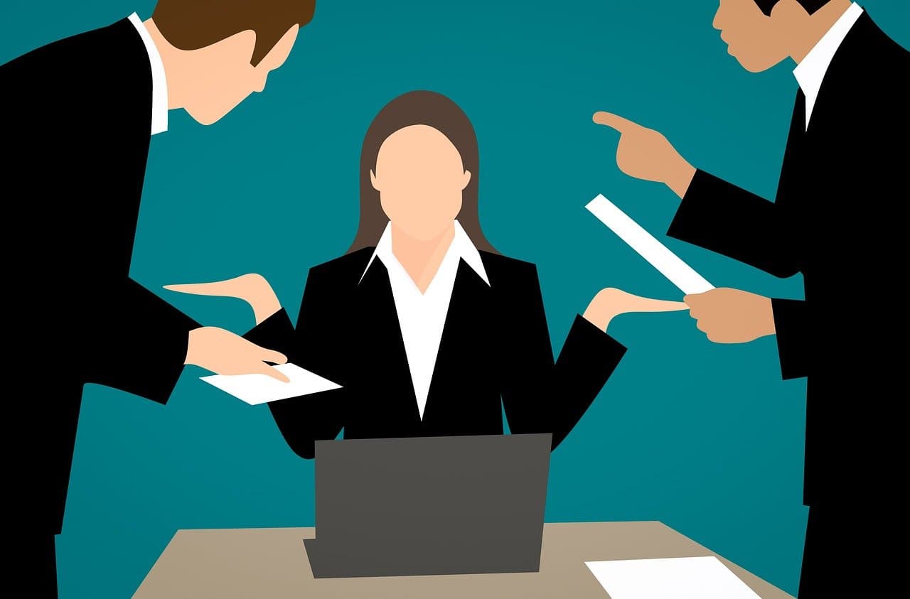 Illustration of coworkers pointing accusing fingers at a woman seated at a laptop
